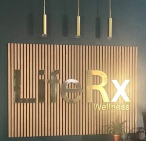 The premium lobby and gold logo sign at LifeRx Wellness center in Willis, TX